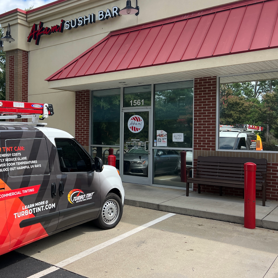 Turbo tint van parked outside a bar with reflective window tint film for security and protection